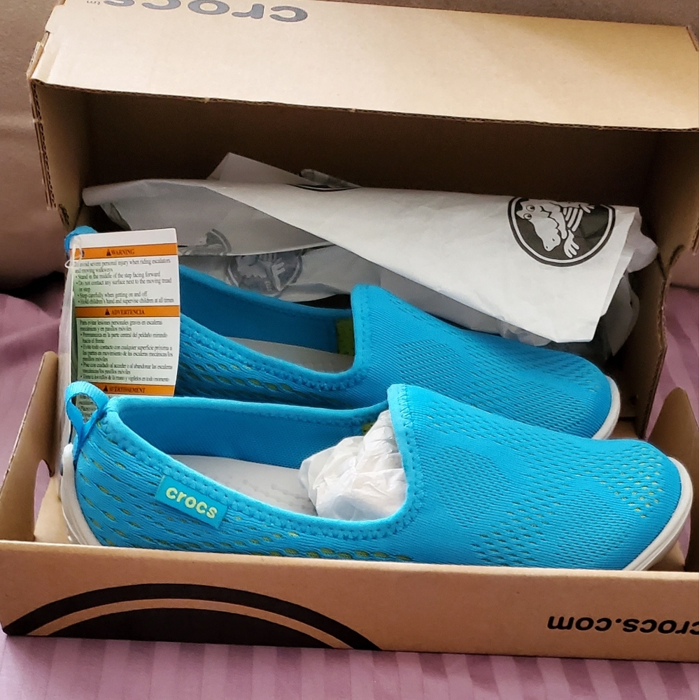 Teal colored slip on women's crocs.